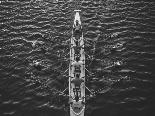 people riding boat on body of water