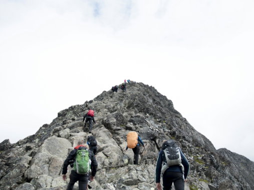 climbers hiking through mountain peak during daytime