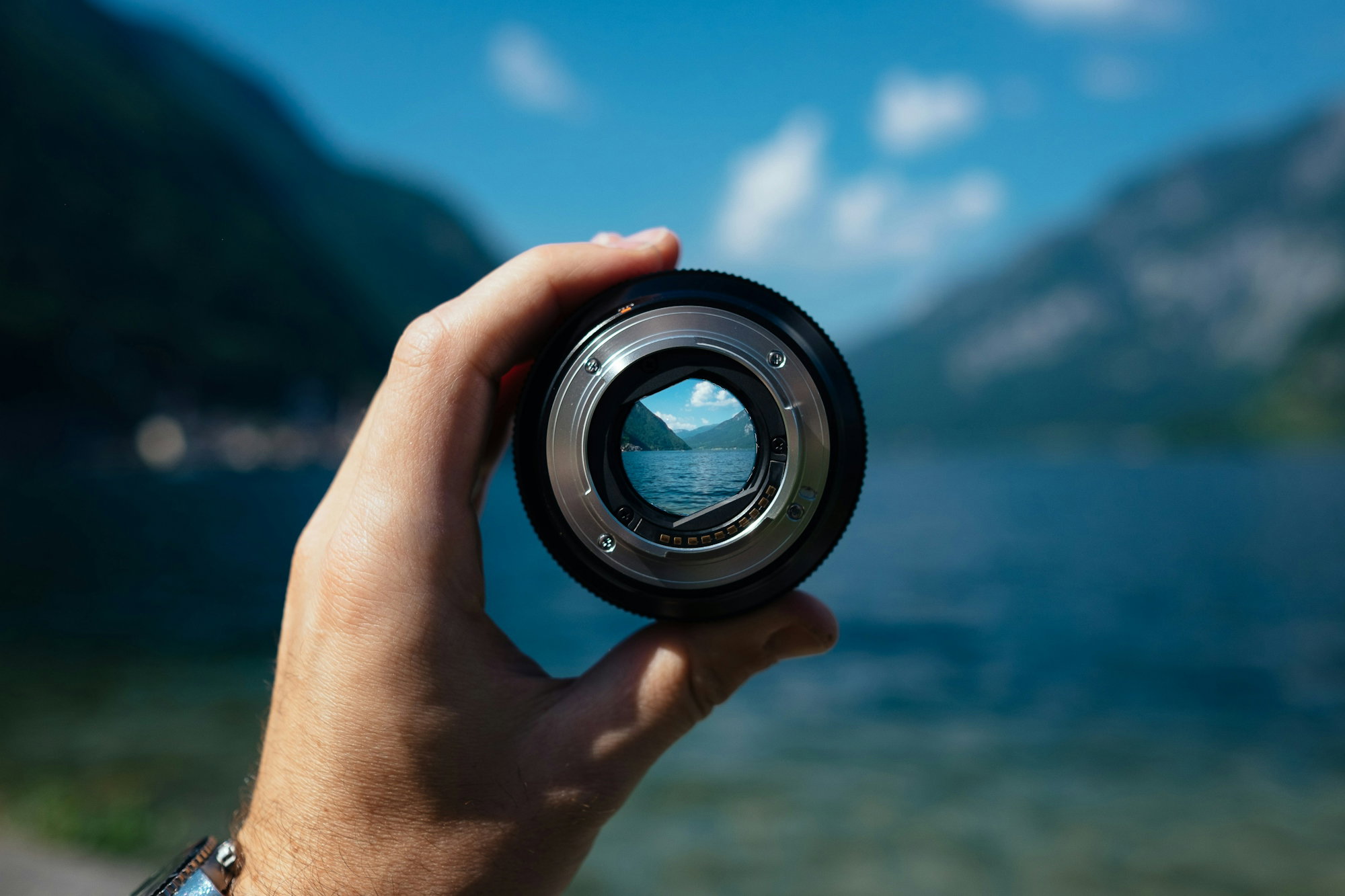 person-holding-camera-lens.jpg person holding camera lens